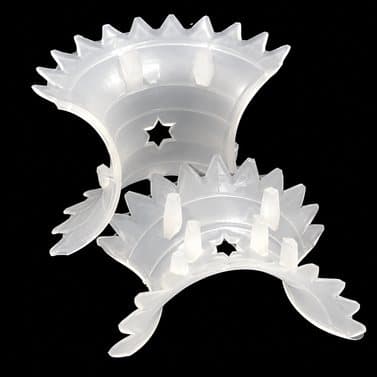 Two translucent plastic intalox saddles on a dark background